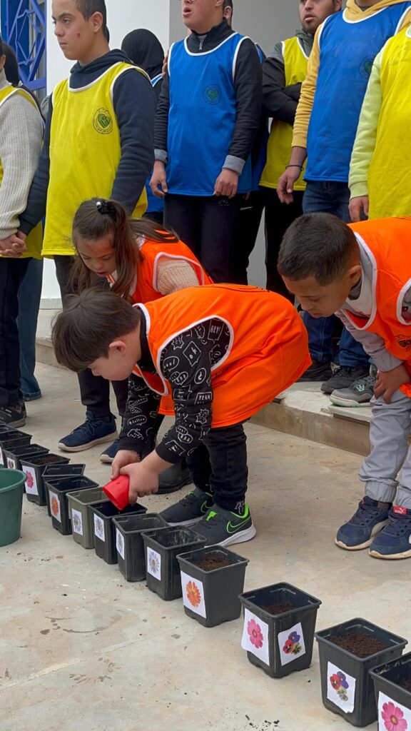 Children participating in the GOMO planting and decoration workshop in Badess